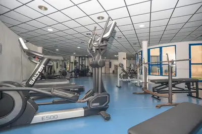 a gym with several treadmills and cardio machines at Holiday Apartment Patacona Beach in Valencia