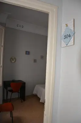 a door leading into a room with a bed at Pensión Moratin in Valencia