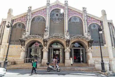 a building with a scooter parked in front of it at Travel Habitat Ático Ciutat Vella. in Valencia