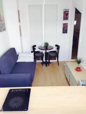 a living room with a blue couch and a table at Valencian Dreams in Valencia