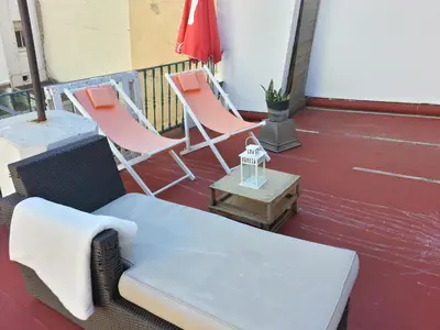 a porch with two chairs and a table and a couch at Valencian Dreams in Valencia
