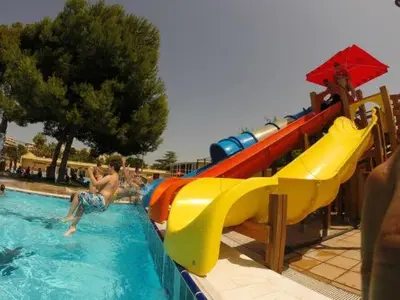 a water slide in a swimming pool with people in it at María montessori, pedagoga in Valencia