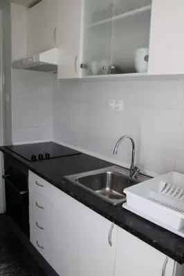 a kitchen with a sink and a counter top at María montessori, pedagoga in Valencia