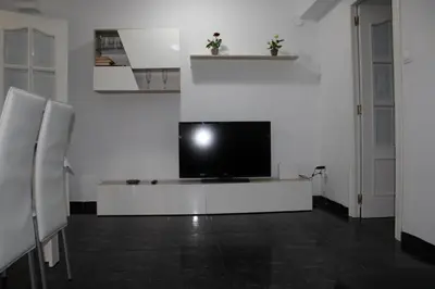 a living room with a tv on a white wall at María montessori, pedagoga in Valencia