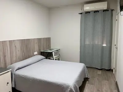 a hospital room with a bed and a window at Hospederia del Pilar in Valencia