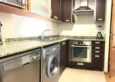 a kitchen with a washing machine and a sink at Sun Apartament Valencia @ City Arts & Sciences + Parking in Valencia