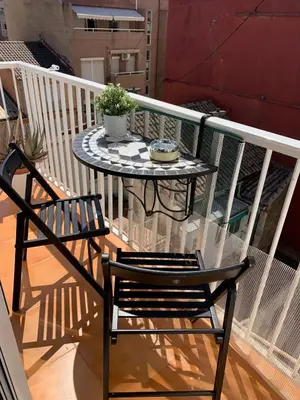 a table and two chairs on a balcony at Big spacious penthouse next to the sea in Valencia