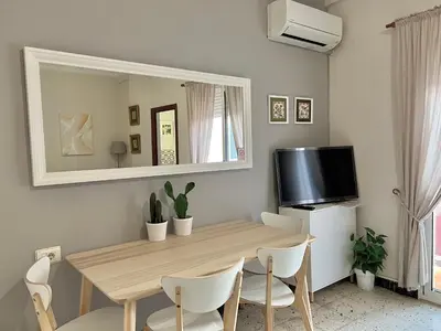 a dining room with a table and a mirror at Big spacious penthouse next to the sea in Valencia