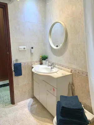 a bathroom with a sink and a mirror at Big spacious penthouse next to the sea in Valencia