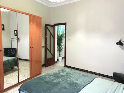 a bedroom with a bed and a sliding glass door at Big spacious penthouse next to the sea in Valencia