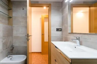 a bedroom with a bed and a desk and a window at ApartUP Mestalla Home in Valencia