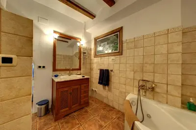 a bathroom with a tub and a sink and a bath tub at Casa Rural Mirador del Salto in Chella
