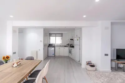 a kitchen and living room with a table and chairs at Carmen Apartment in Valencia