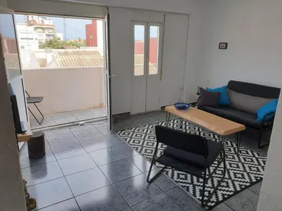 a living room with a couch and a table at Apartment 400 meters from the beach in Valencia