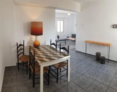 a dining room with a table with a chessboard on it at Apartment 400 meters from the beach in Valencia