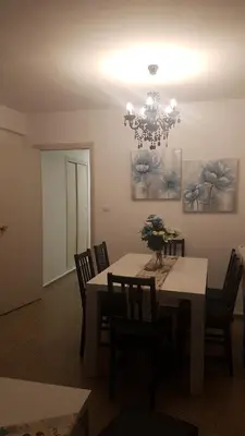 a dining room with a table with chairs and a chandelier at Relaxed Space in the beach in Puerto de Sagunto