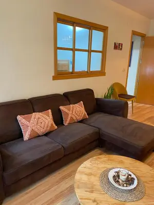 a brown couch in a living room with a table at MÍ casa YOUR HOME in Valencia