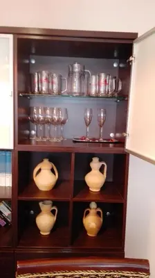 a shelf with wine glasses and vases on it at MÍ casa YOUR HOME in Valencia