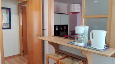 a kitchen counter with a coffee maker and a mirror at MÍ casa YOUR HOME in Valencia