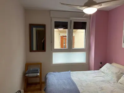 a bedroom with a bed and a window at MÍ casa YOUR HOME in Valencia