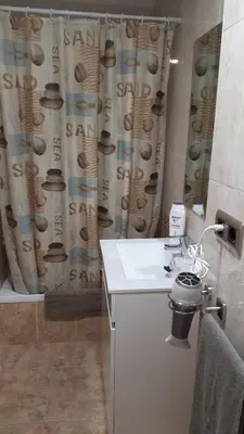 a bathroom with a sink and a shower curtain at Casa Pueblo Alzira No Compartida in Alzira