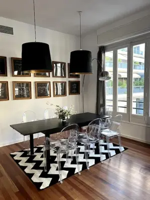 a dining room with a black and white table and chairs at San Vicente in Valencia