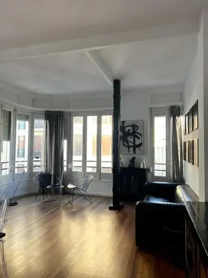 a living room with a couch and chairs and windows at San Vicente in Valencia