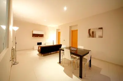 a living room with a dining room table and a couch at RealRent Marina Real in Valencia