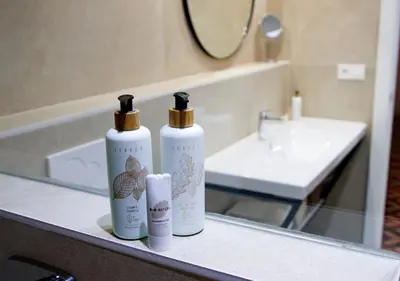 two bottles ofodorizers sitting on a counter in a bathroom at VALOLA Boutique Rooms in Valencia