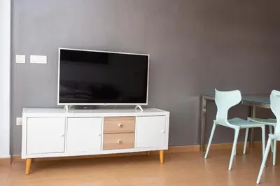 a white entertainment center with a flat screen tv on it at 4-Seasons Penthouse Cullera in Cullera