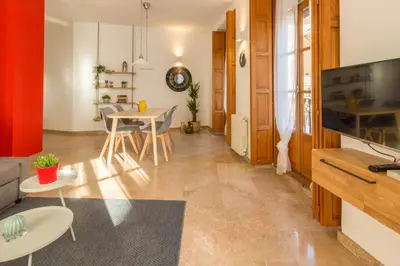 a living room with a table and a dining room at Lovely Apartment! in Valencia