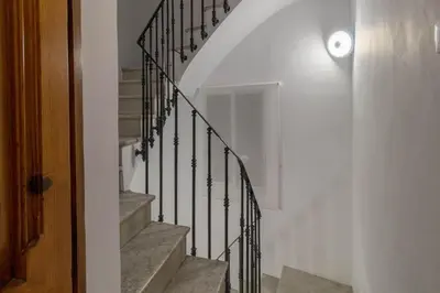 a staircase with black railings in a house at Lovely Apartment! in Valencia