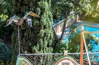 a kite hanging from a chain next to a tree at Apartamentos Gaudi Style in Náquera