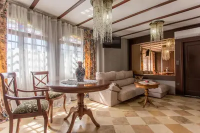 a living room with a table and a couch at Apartamentos Gaudi Style in Náquera