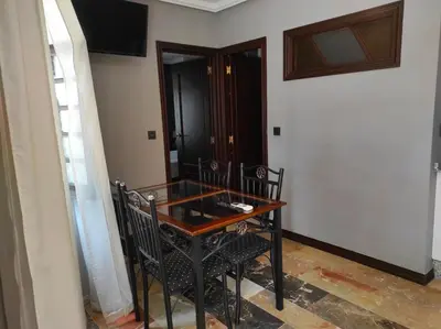 a dining room table and chairs in a room at Apartamentos Gaudi Style in Náquera