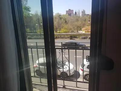 a view of a parking lot from a window at Domus Valencia Apartamentos centro frente a Torres de Serrano in Valencia