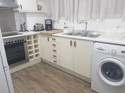a kitchen with a washing machine and a sink at Domus Valencia Apartamentos centro frente a Torres de Serrano in Valencia
