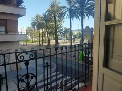 a balcony with a view of a street and palm trees at Apartamento con vistas a la Marina Real in Valencia