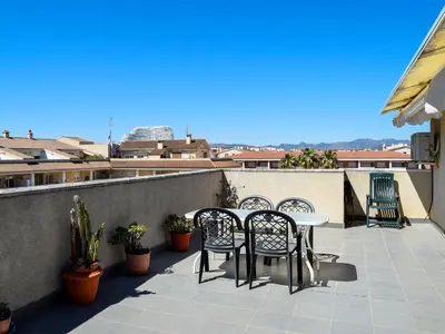 a patio with chairs and a table on a balcony at Apartamentos Canet de Berenguer 3000 in Canet de Berenguer