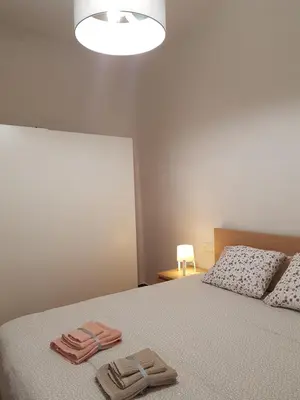 a bedroom with a bed with two towels on it at Casual House Valencia in Valencia