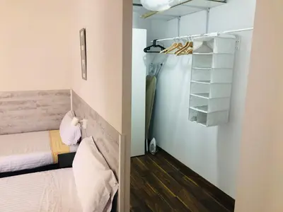 a small room with a bed and a closet at Mar & City Apartment in Valencia