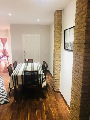 a dining room with a black and white table and chairs at Mar & City Apartment in Valencia