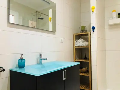 a bathroom with a blue sink and a mirror at Mar & City Apartment in Valencia