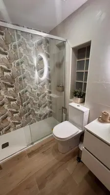 a bathroom with a shower and a toilet and a sink at Precioso chalet en la playa de Tavernes de la Valldigna in Tavernes de Valldigna