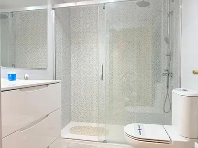 a bathroom with a glass shower with a toilet at Travel Habitat Palau De Les Arts in Valencia