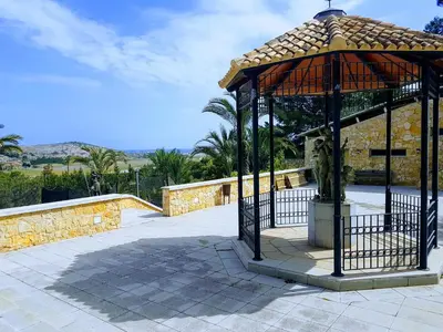 a gazebo with a statue in the middle at El Collado in Cullera