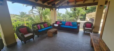 a porch with chairs and pillows on a balcony at El Collado in Cullera
