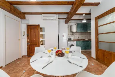 a white dining room with a white table and chairs at My Loft 4 You Temple in Valencia