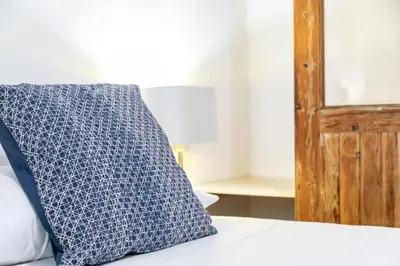 a blue pillow sitting on top of a bed at My Loft 4 You Temple in Valencia