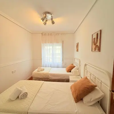 a bedroom with two beds and a window at Travel Habitat Mestalla in Valencia